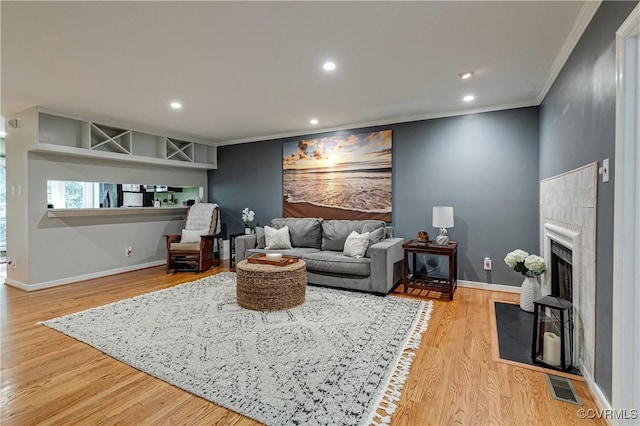 12125 Shore View Dr, Henrico, VA 23233 - living area with ornamental molding, baseboards, a fireplace with flush hearth, light wood-type flooring, and recessed lighting