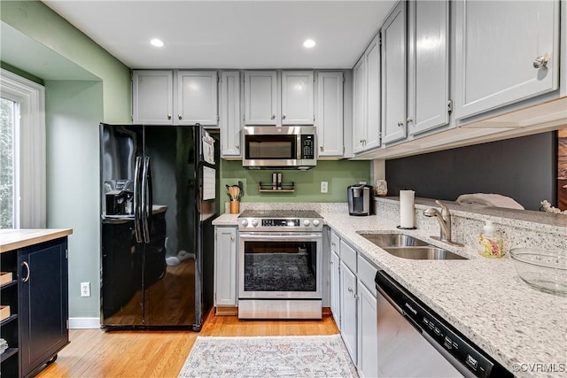12125 Shore View Dr, Henrico, VA 23233 - kitchen with stainless steel appliances, a sink, light wood-style flooring, recessed lighting, and light stone countertops