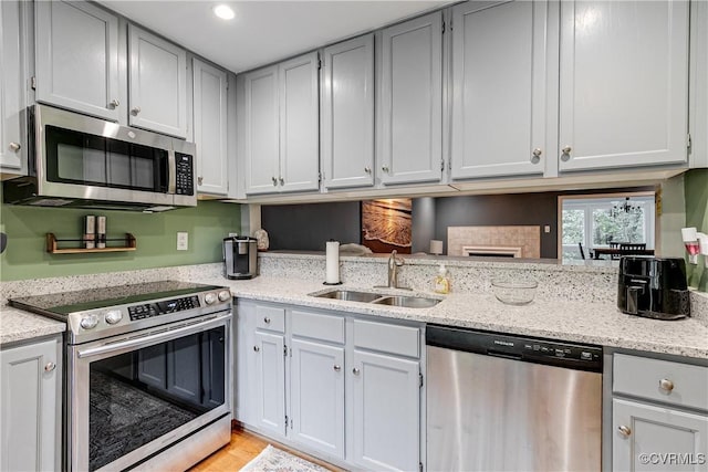12125 Shore View Dr, Henrico, VA 23233 - kitchen featuring appliances with stainless steel finishes, a sink, light stone countertops, and recessed lighting