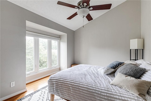 12125 Shore View Dr, Henrico, VA 23233 - bedroom featuring vaulted ceiling, multiple windows, light wood finished floors, baseboards, and ceiling fan