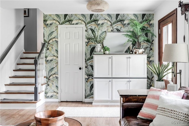8415 Freestone Ave, Henrico, VA 23229 - living area featuring wallpapered walls, light wood-style flooring, stairway, an accent wall, and baseboards