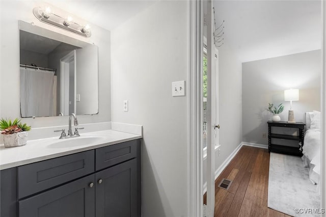 12203 King Cotton Ct, Midlothian, VA 23112 - bathroom with vanity, hardwood / wood-style floors, and baseboards