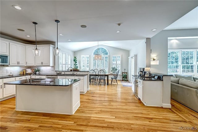 3006 Calcutt Dr, Midlothian, VA 23113 - kitchen featuring a peninsula, light wood finished floors, white cabinetry, and lofted ceiling