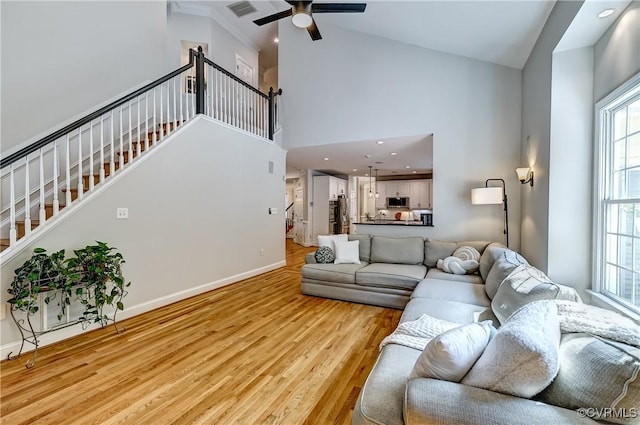 3006 Calcutt Dr, Midlothian, VA 23113 - living room featuring a towering ceiling, stairway, a ceiling fan, light wood finished floors, and recessed lighting