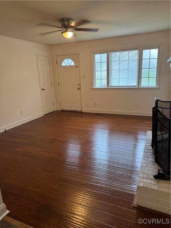 3530 Gilbert St, Hopewell, VA 23860 - entrance foyer featuring a ceiling fan, dark wood finished floors, and a wood stove
