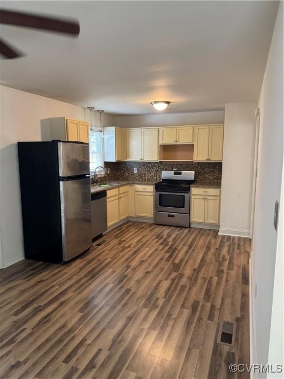3530 Gilbert St, Hopewell, VA 23860 - kitchen with appliances with stainless steel finishes, dark countertops, and decorative backsplash