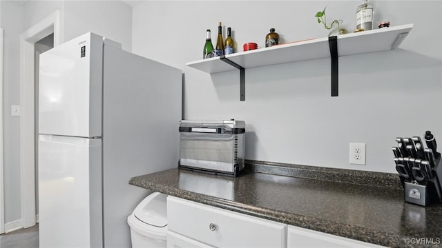 2207 Marroit Rd, Henrico, VA 23229 - kitchen with freestanding refrigerator, open shelves, and white cabinetry