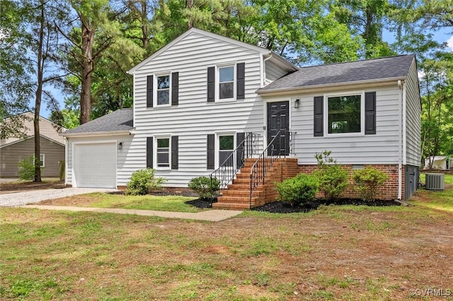 1121 Collingwood Dr, North Prince George, VA 23860 - split level home featuring central AC, a garage, a front lawn, and driveway