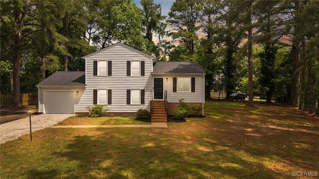 1121 Collingwood Dr, North Prince George, VA 23860 - tri-level home featuring gravel driveway, an attached garage, a front lawn, roof with shingles, and view of scattered trees