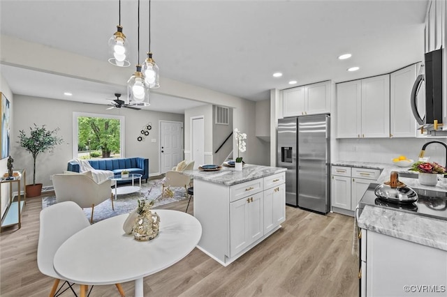 1121 Collingwood Dr, North Prince George, VA 23860 - kitchen with stainless steel appliances, a center island, white cabinetry, open floor plan, and recessed lighting