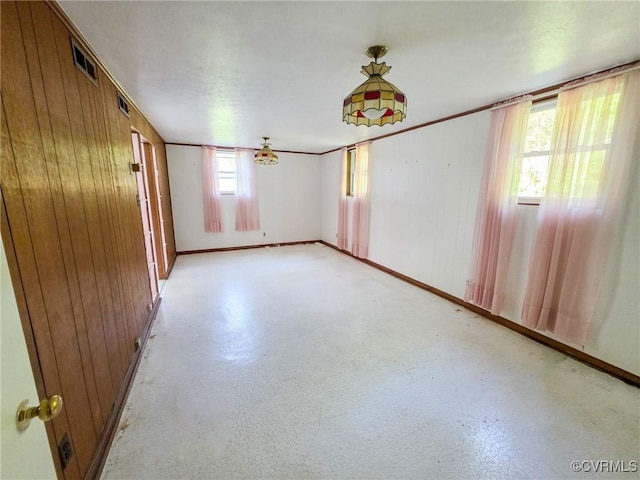 16121 Rowlett Rd, Chesterfield, VA 23838 - empty room featuring finished concrete flooring, wood walls, and baseboards