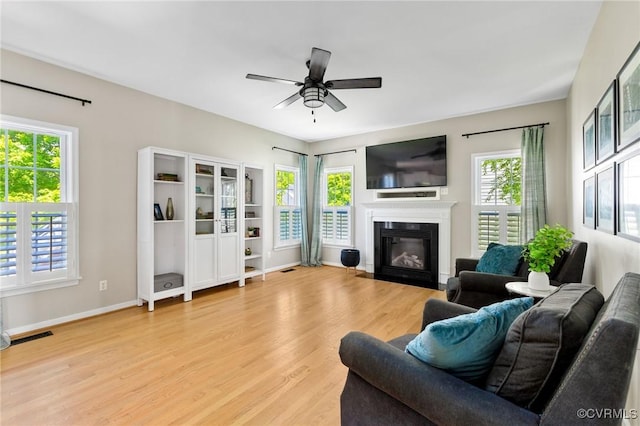 4824 Hilbay Ter, Moseley, VA 23120 - living room featuring a ceiling fan, light wood-type flooring, a fireplace with flush hearth, and baseboards
