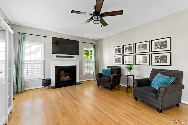 4824 Hilbay Ter, Moseley, VA 23120 - living area featuring a ceiling fan, light wood-style floors, a fireplace with flush hearth, and baseboards
