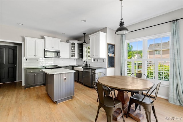 4824 Hilbay Ter, Moseley, VA 23120 - kitchen with stainless steel appliances, a center island, white cabinetry, tasteful backsplash, and light wood-style floors