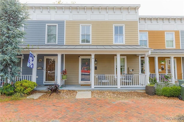 506 N 28th St, Richmond, VA 23223 - view of front of house featuring a standing seam roof, metal roof, and a porch