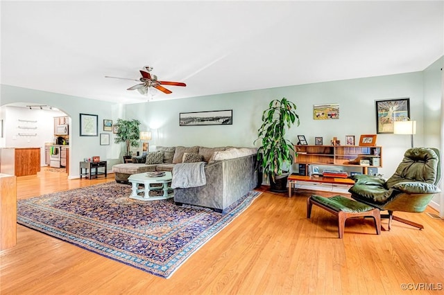 506 N 28th St, Richmond, VA 23223 - living area with ceiling fan, arched walkways, and wood finished floors