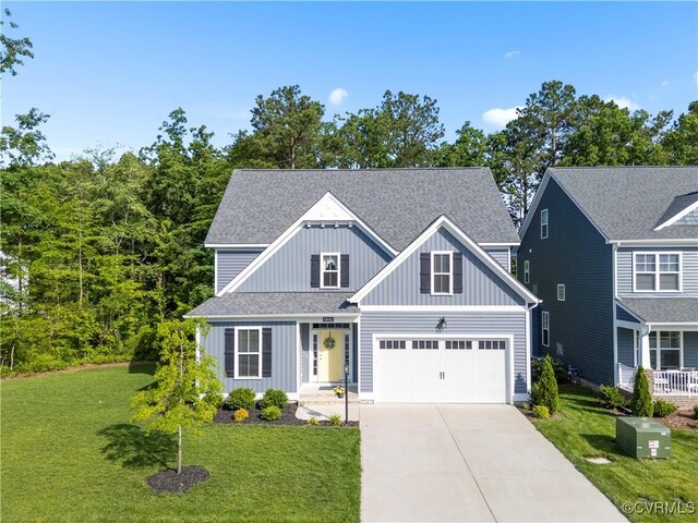 13042 Fieldfare Dr, Midlothian, VA 23112 - view of front of home featuring board and batten siding, concrete driveway, a front yard, and roof with shingles