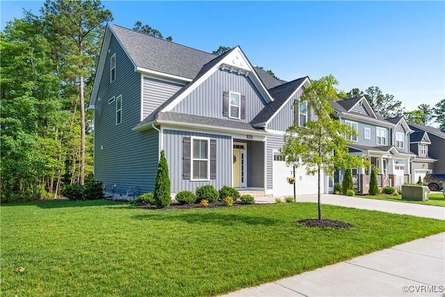 13042 Fieldfare Dr, Midlothian, VA 23112 - view of front of property with concrete driveway, board and batten siding, an attached garage, a front yard, and roof with shingles