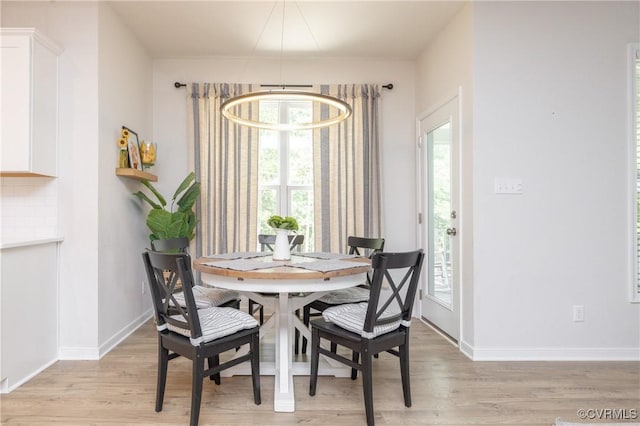 13042 Fieldfare Dr, Midlothian, VA 23112 - dining space with light wood finished floors, a chandelier, and baseboards
