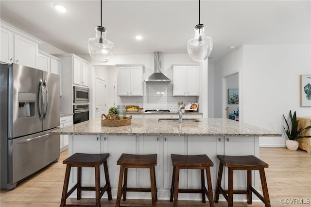 15637 Cedarville Dr, Midlothian, VA 23112 - kitchen with stainless steel appliances, wall chimney exhaust hood, a sink, light wood-type flooring, and recessed lighting