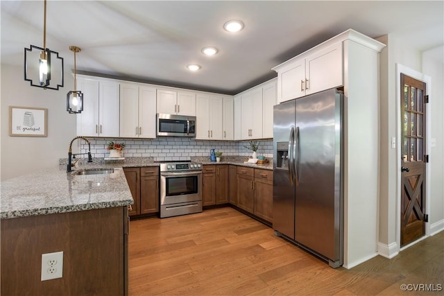5415 Edgefield St, Henrico, VA 23227 - kitchen featuring stainless steel appliances, a sink, light wood-style floors, backsplash, and recessed lighting