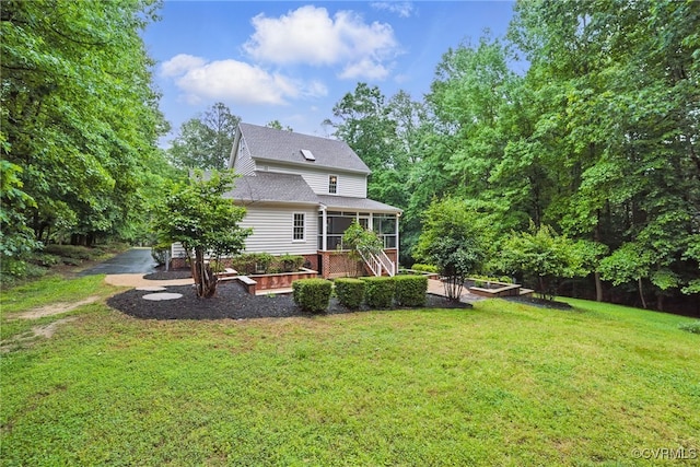 11320 Glendevon Rd, Chesterfield, VA 23838 - rear view of house with a vegetable garden, a sunroom, a yard, and a shingled roof