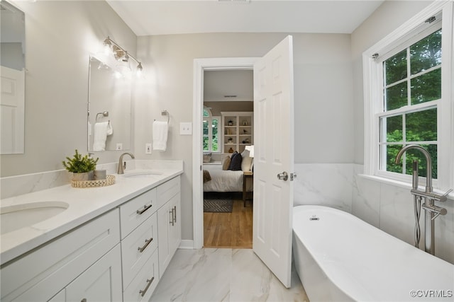 11320 Glendevon Rd, Chesterfield, VA 23838 - bathroom with marble look tiles, double vanity, a soaking tub, and ensuite bath