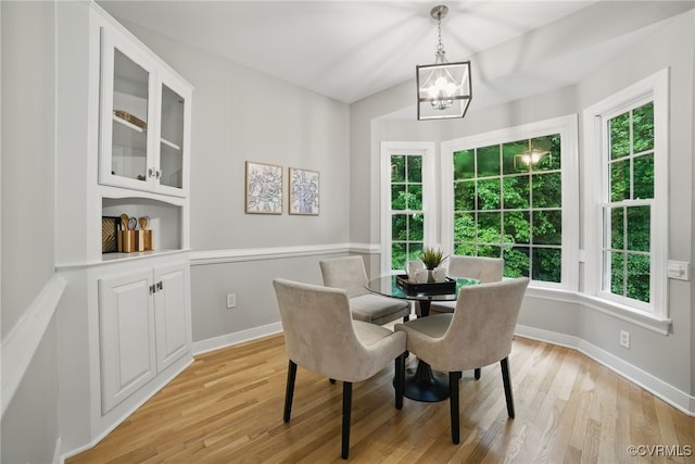 11320 Glendevon Rd, Chesterfield, VA 23838 - dining area with a chandelier, light wood-type flooring, and baseboards