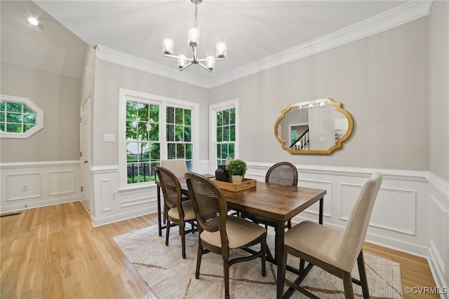 11320 Glendevon Rd, Chesterfield, VA 23838 - dining area with a chandelier, a decorative wall, crown molding, light wood finished floors, and a wainscoted wall
