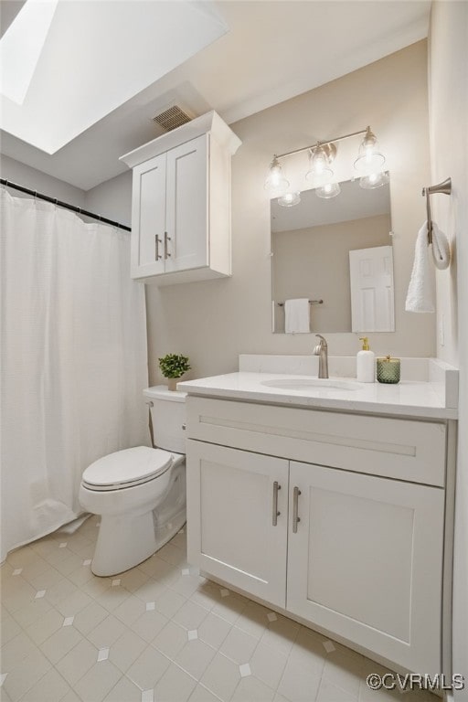 11320 Glendevon Rd, Chesterfield, VA 23838 - bathroom with vanity, toilet, tile patterned flooring, a skylight, and a shower with curtain