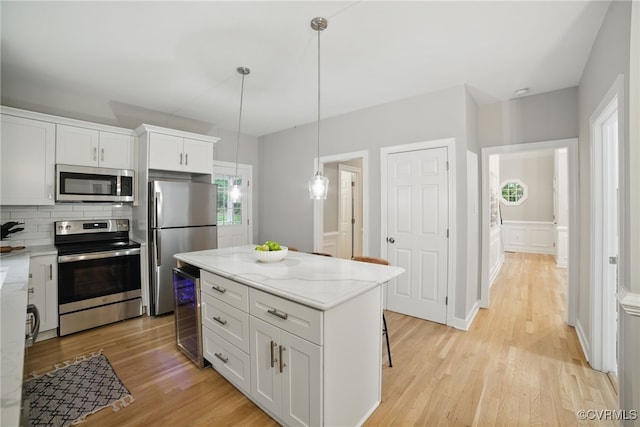 11320 Glendevon Rd, Chesterfield, VA 23838 - kitchen featuring stainless steel appliances, wine cooler, light wood finished floors, and white cabinetry