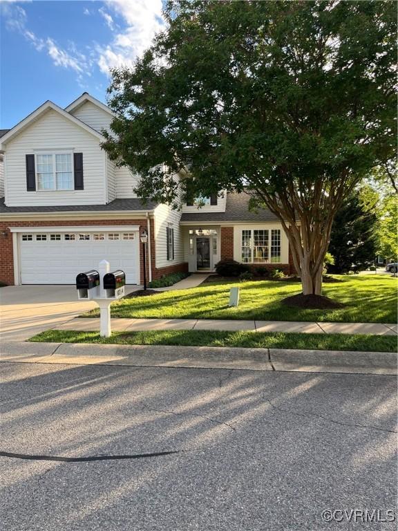 10214 Mobjack Ave Unit 2, Glen Allen, VA 23060 - view of front of home with an attached garage, brick siding, driveway, and a front yard