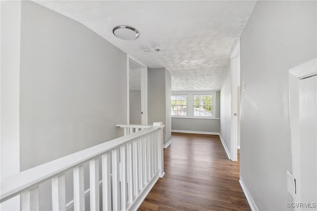 512 St Andrew St, Petersburg, VA 23803 - corridor with dark wood finished floors, baseboards, a textured ceiling, and an upstairs landing