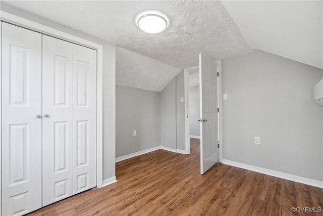 512 St Andrew St, Petersburg, VA 23803 - bonus room featuring baseboards, light wood-type flooring, vaulted ceiling, and a textured ceiling