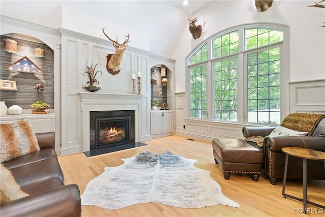 13519 Pungo Ct, Chesterfield, VA 23838 - living room featuring a decorative wall, lofted ceiling, a fireplace with flush hearth, light wood-type flooring, and built in features