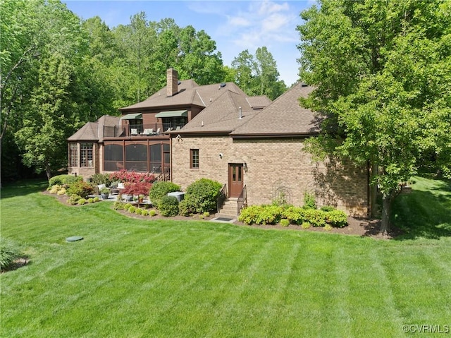 13519 Pungo Ct, Chesterfield, VA 23838 - back of house with brick siding, a chimney, a balcony, a lawn, and a sunroom