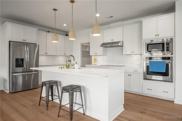 7025 Leire Dr, Chester, VA 23832 - kitchen featuring appliances with stainless steel finishes, a sink, under cabinet range hood, light countertops, and recessed lighting