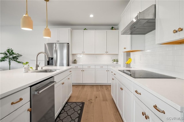 7025 Leire Dr, Chester, VA 23832 - kitchen featuring stainless steel appliances, a sink, under cabinet range hood, light countertops, and white cabinetry