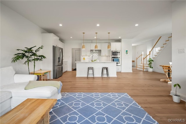7025 Leire Dr, Chester, VA 23832 - living room with light wood-type flooring, stairs, recessed lighting, and baseboards