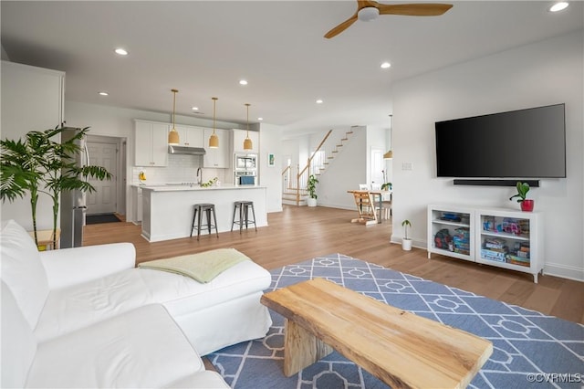 7025 Leire Dr, Chester, VA 23832 - living room with stairway, ceiling fan, light wood finished floors, recessed lighting, and baseboards