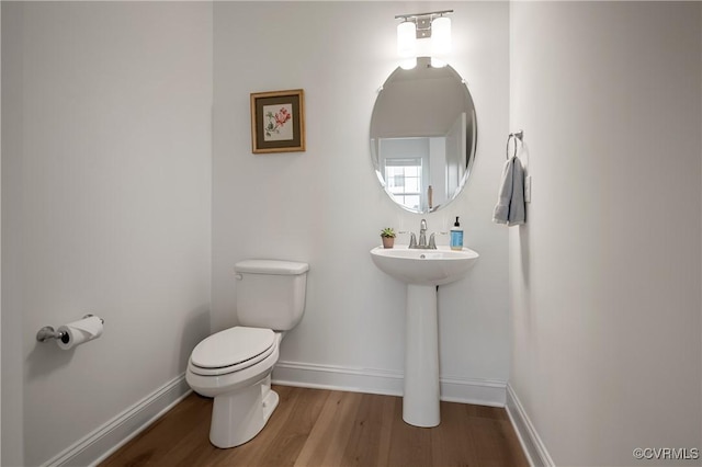 7025 Leire Dr, Chester, VA 23832 - half bath featuring toilet, wood finished floors, and baseboards