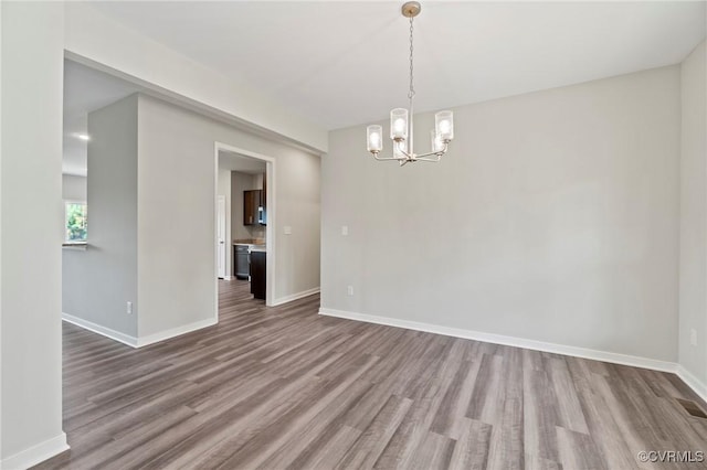 1343 Buckners Ln, Mineral, VA 23117 - unfurnished dining area featuring a chandelier, wood finished floors, and baseboards