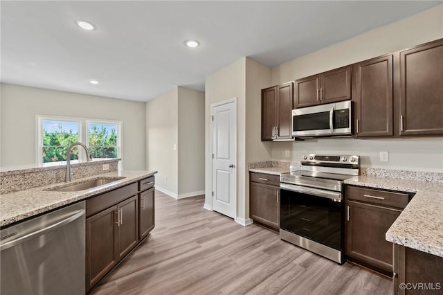1343 Buckners Ln, Mineral, VA 23117 - kitchen with stainless steel appliances, a sink, dark brown cabinetry, light wood finished floors, and recessed lighting