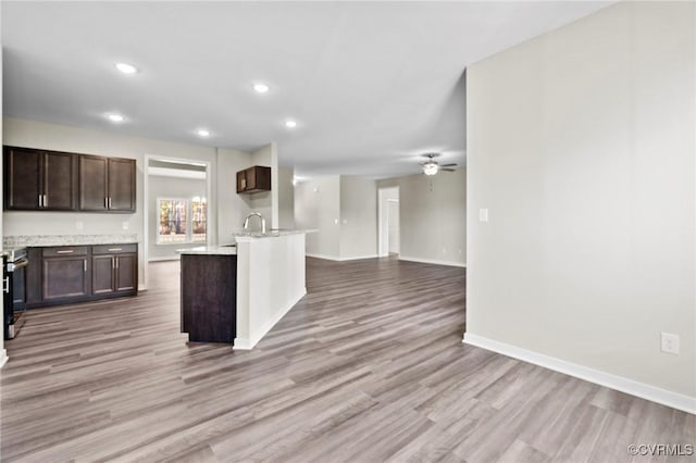 1343 Buckners Ln, Mineral, VA 23117 - kitchen with light countertops, open floor plan, dark brown cabinets, ceiling fan, and light wood-style flooring
