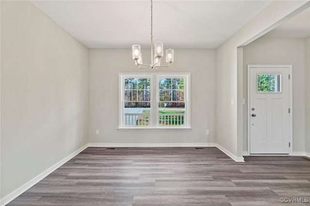 1343 Buckners Ln, Mineral, VA 23117 - unfurnished dining area with a chandelier, wood finished floors, and baseboards