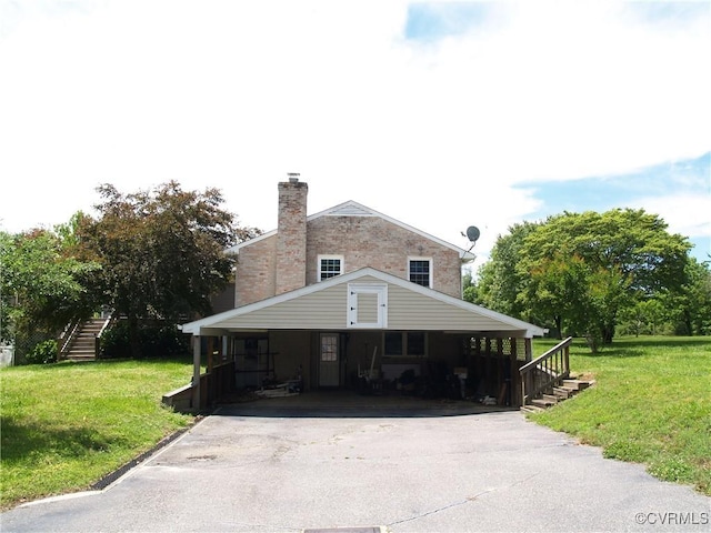 11001 Old Church Rd, New Kent, VA 23124 - view of front of house featuring asphalt driveway, a chimney, a front lawn, a carport, and stairway
