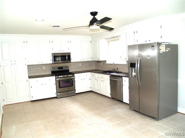 11001 Old Church Rd, New Kent, VA 23124 - kitchen with stainless steel appliances, a sink, dark countertops, and tasteful backsplash