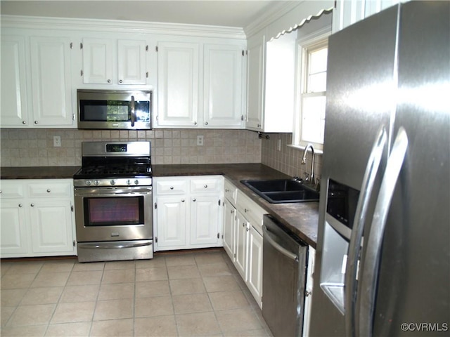 11001 Old Church Rd, New Kent, VA 23124 - kitchen with appliances with stainless steel finishes, a sink, dark countertops, light tile patterned flooring, and white cabinets