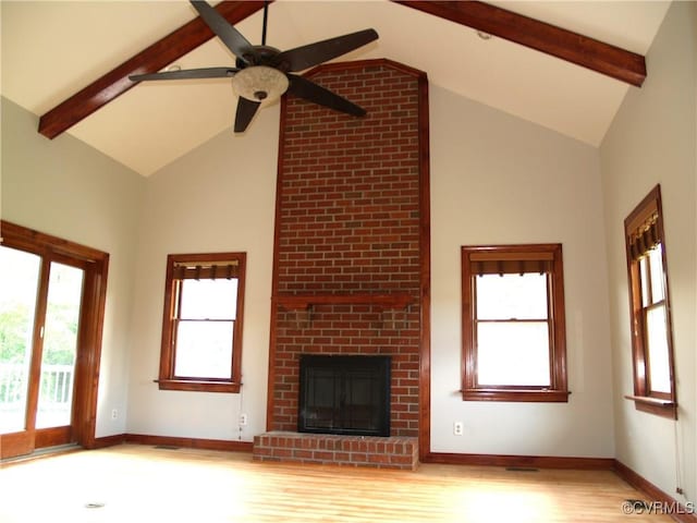 11001 Old Church Rd, New Kent, VA 23124 - unfurnished living room featuring high vaulted ceiling, beamed ceiling, light wood-style flooring, a ceiling fan, and a fireplace