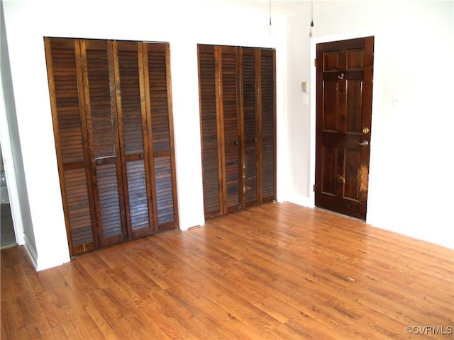 11001 Old Church Rd, New Kent, VA 23124 - unfurnished bedroom with multiple closets and light wood-type flooring